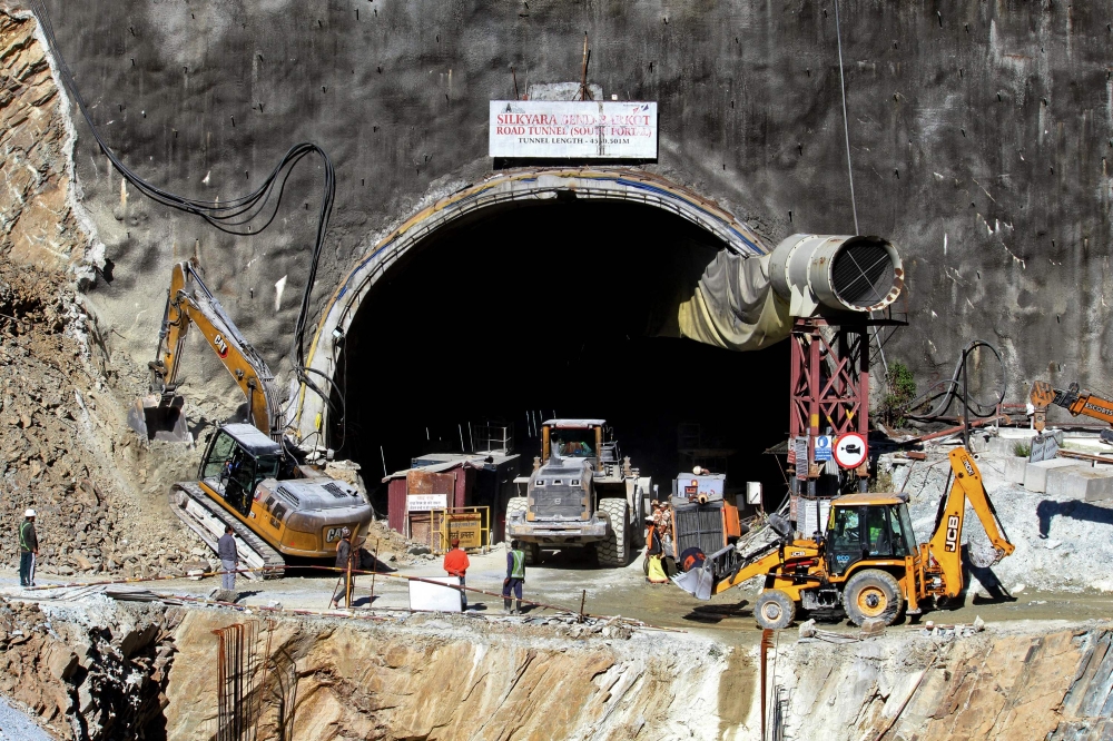 Rescue workers stand at an entrance of the under construction road tunnel, days after it collapsed in the Uttarkashi district of India's Uttarakhand state on November 18, 2023. Photo by AFP