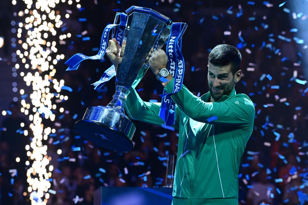 Serbia's Novak Djokovic poses with the trophy after winning the final match against Italy's Jannik Sinner at the ATP Finals tennis tournament in Turin on November 19, 2023. (Photo by Tiziana Fabi / AFP)