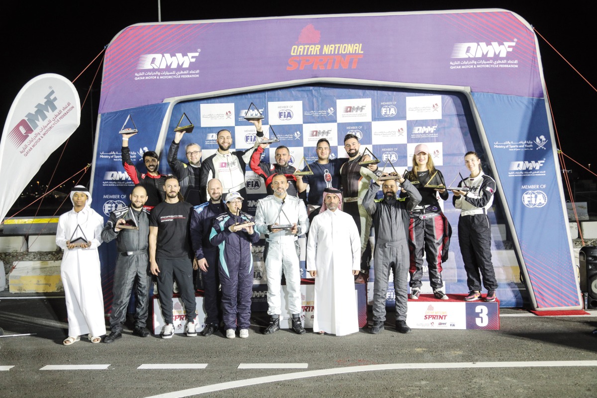 The podium winners pose for a photo with officials after the penultimate round of the QNC.