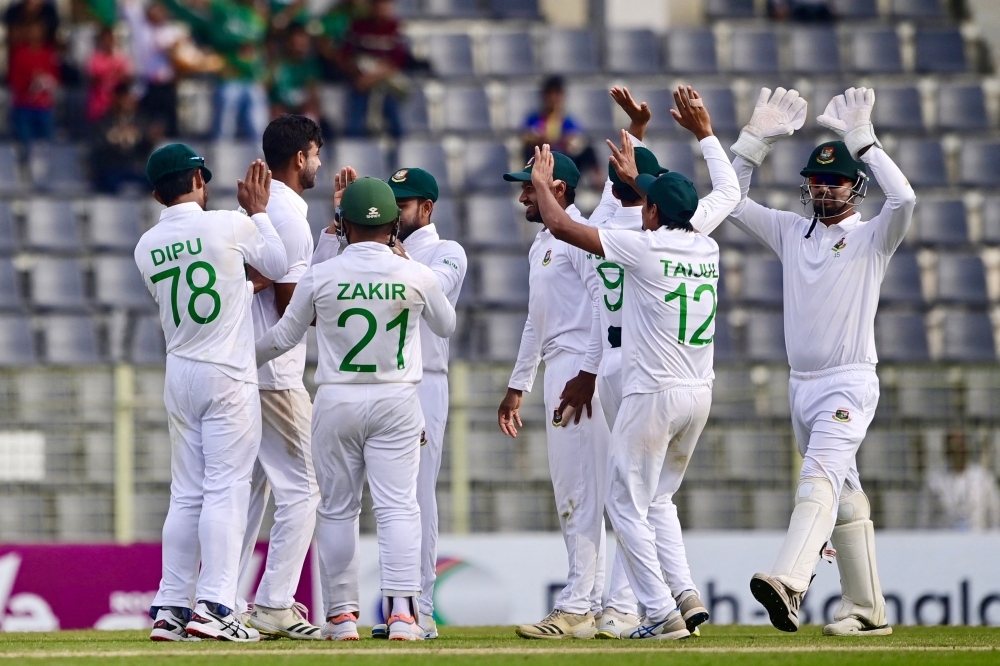 Bangladesh players celebrate after the dismissal of New Zealand's Tom Blundell during the second day of the first Test cricket match between Bangladesh and New Zealand at the Sylhet International Cricket Stadium in Sylhet on November 29, 2023. (Photo by Munir uz Zaman / AFP)