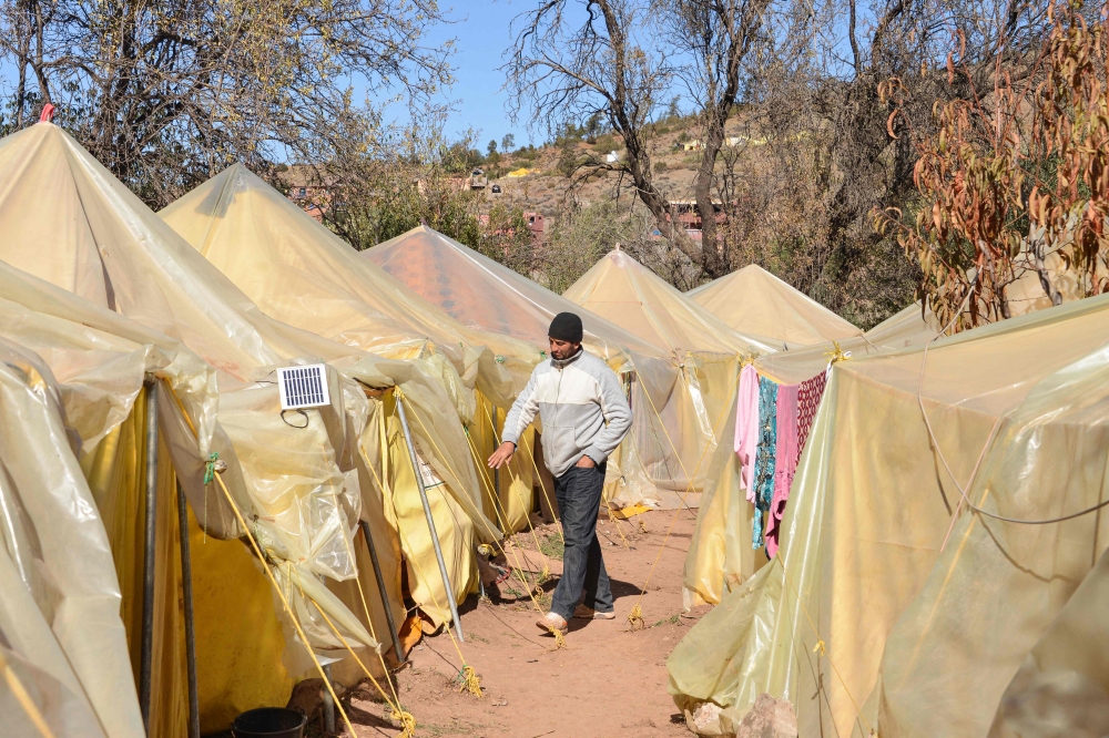 A displaced Moroccan man walks in a temporary camp set up following the September 8 earthquake, in the hamlet of Imzilne in the Ouirgane commune, some 60 kilometres south of Marrakesh, on November 27, 2023. Photo by AFP