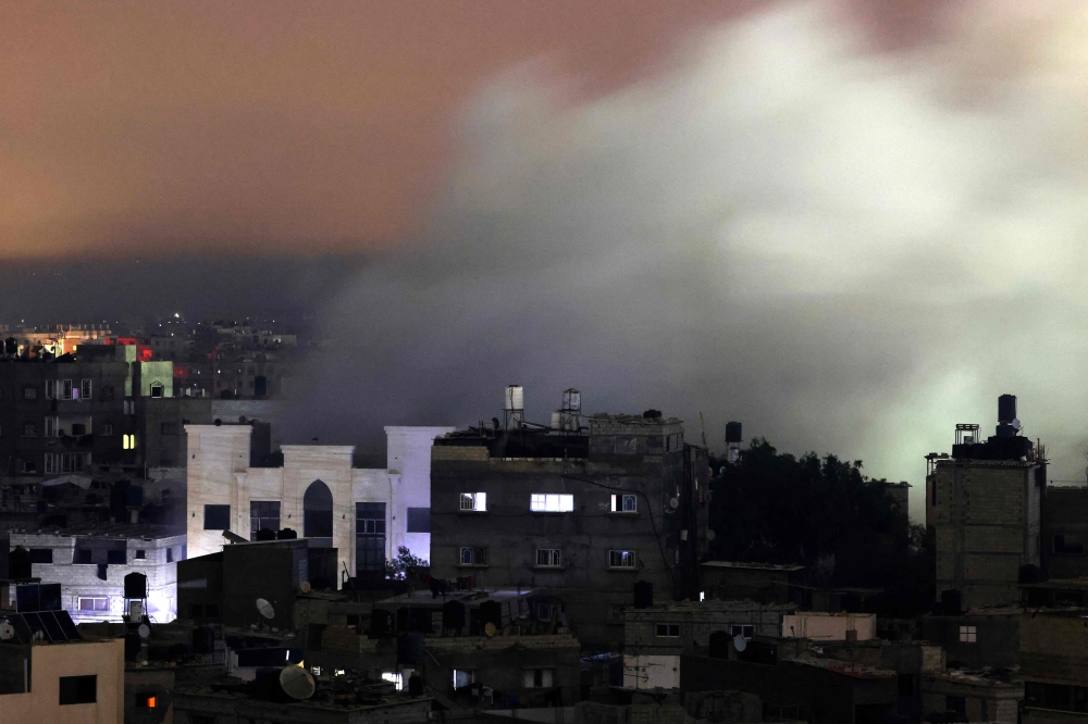 Smoke billows following an Israeli strike in Rafah in the southern Gaza Strip on December 8, 2023. (Photo by Mahmud Hams / AFP)