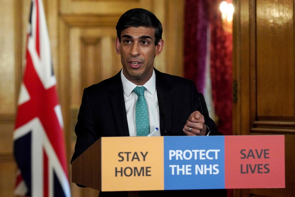 A handout image released by 10 Downing Street, shows Britain's Chancellor of the Exchequer Rishi Sunak speaking during a remote press conference to update the nation on the Covid-19 pandemic, inside 10 Downing Street in central London on March 26, 2020. Photo by Pippa FOWLES / 10 Downing Street / AFP