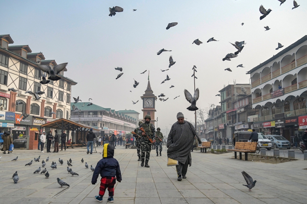 Indian paramilitary troopers patrol along a road in Srinagar on December 11, 2023. (Photo by Tauseef Mustafa / AFP)