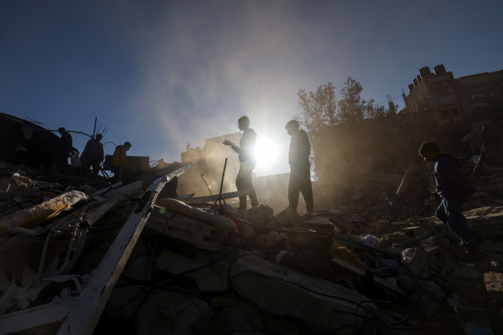 Palestinian youths check debris following Israeli bombardment on Rafah, in the southern Gaza Strip, on December 15, 2023. (Photo by Mohammed Abed / AFP)
 