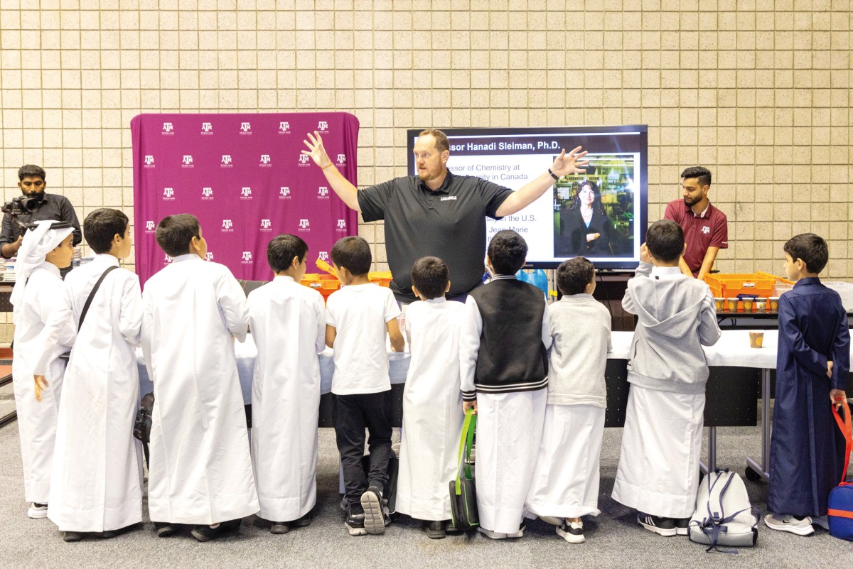 Children see a demonstration about ‘Genome Heroes’ app at the booth of Qatar Precision Health Institute during the National Science Research and Innovation Week 2023.