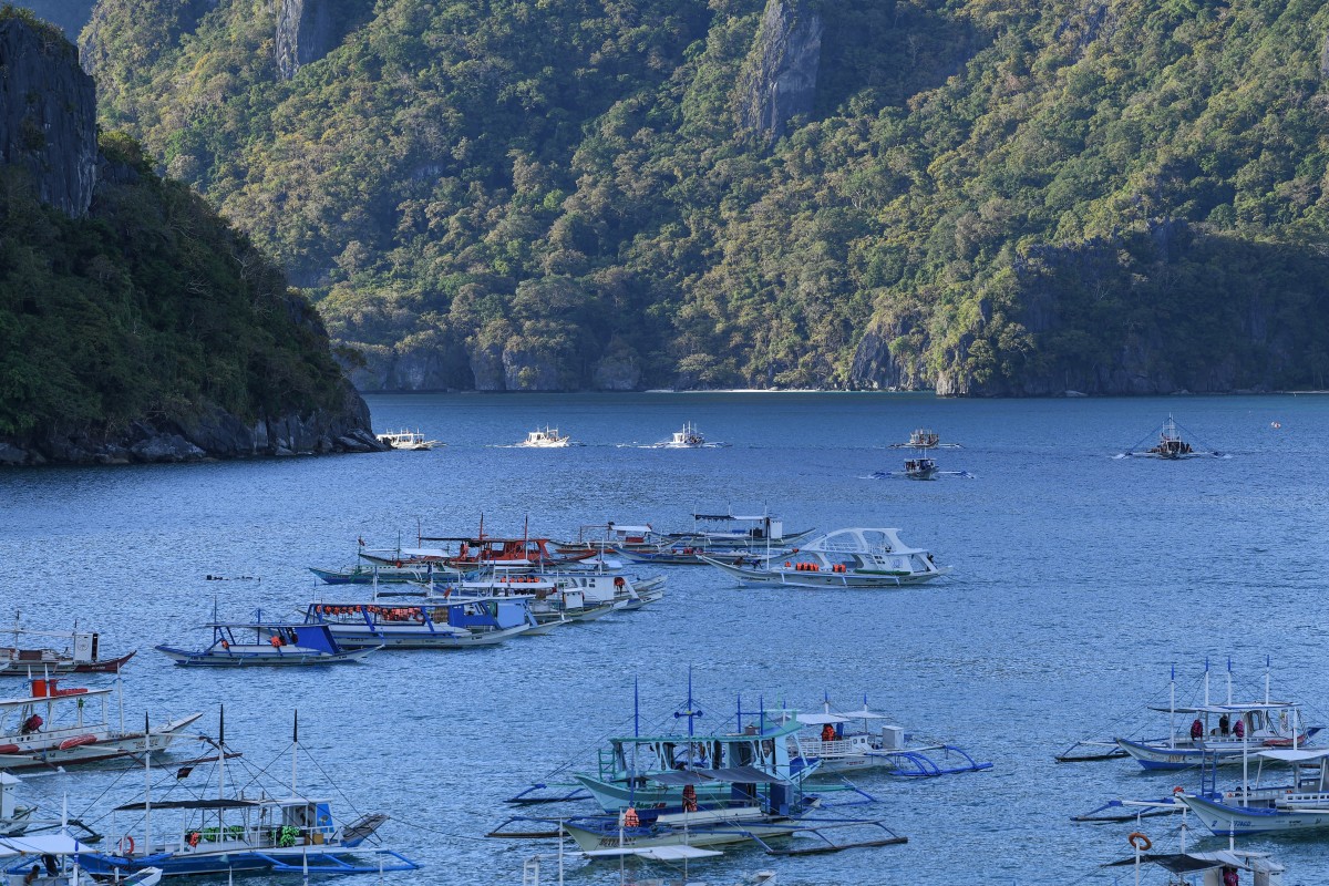 This photo taken on December 11, 2023 shows tour boats sailing back to El Nido, Palawan province. (Photo by Ted ALJIBE / AFP)

