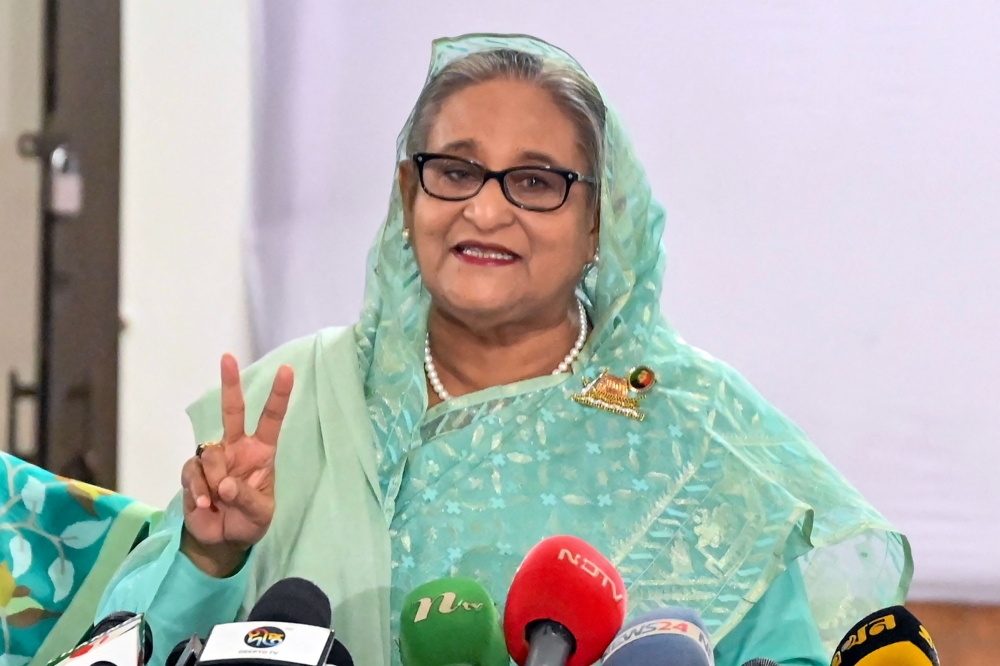 Bangladesh's Prime Minister Sheikh Hasina gestures after casting her vote casts at a polling station in Dhaka on January 7, 2024. (Photo by AFP)
