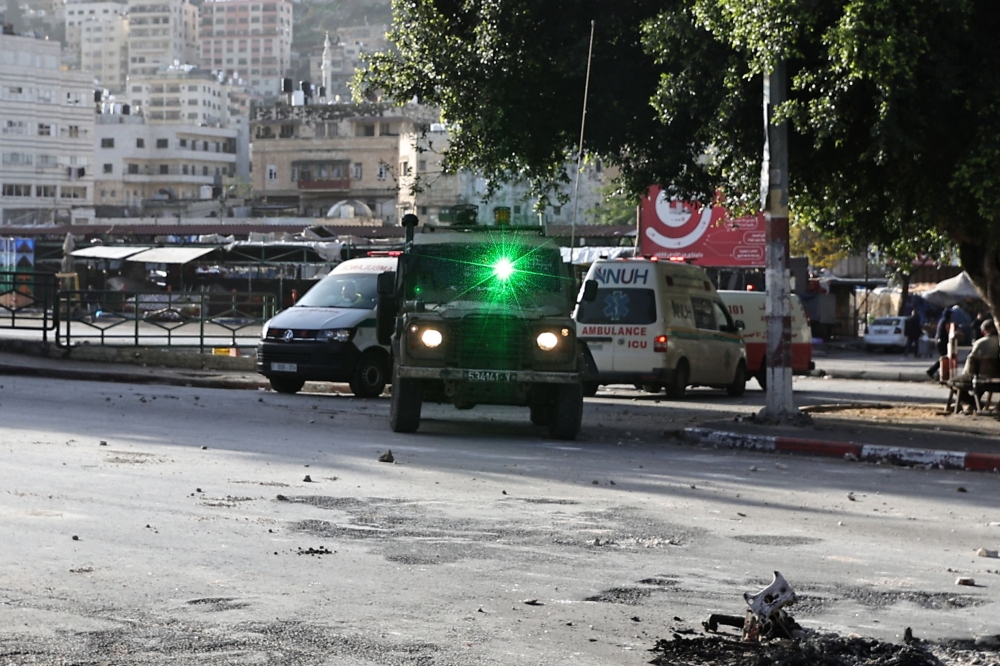 Israeli troops enter Nablus during a raid on the occupied West Bank city on January 10, 2024. (Photo by Zain JAAFAR / AFP)

