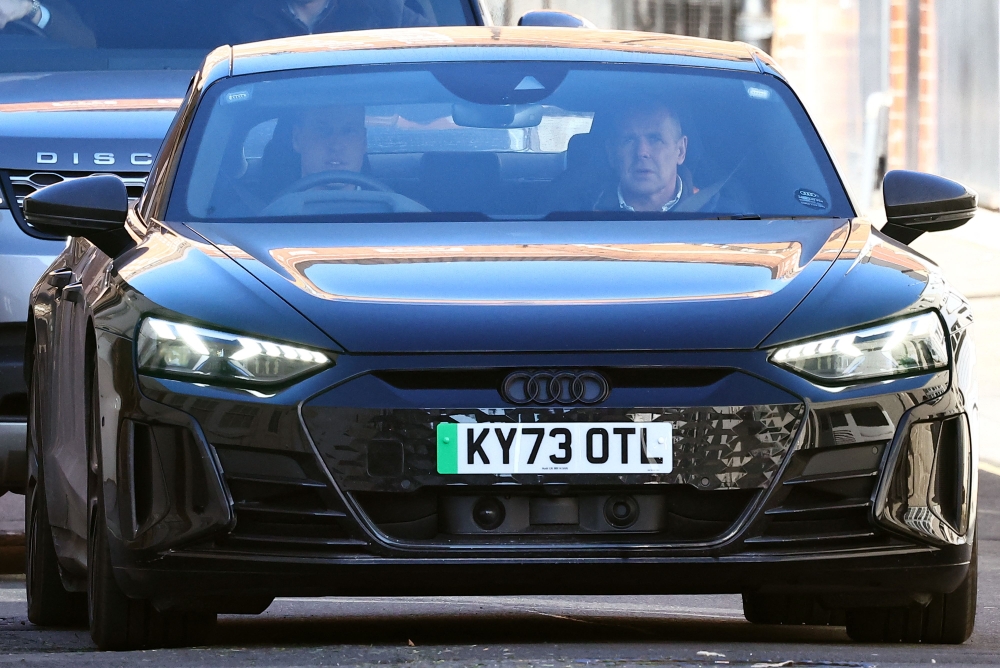 Britain's Prince William, Prince of Wales (L) drives himself away from the London Clinic in London on January 18, 2024 where his wife Britain's Catherine, Princess of Wales, underwent surgery. (Photo by HENRY NICHOLLS / AFP)
