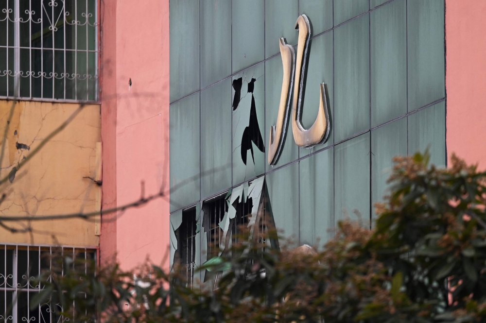 Broken windows are seen at the Yngcai school, where 13 children died in a fire, in Yanshanpu, village in China痴 central Henan province on January 21, 2024. Photo by GREG BAKER / AFP
