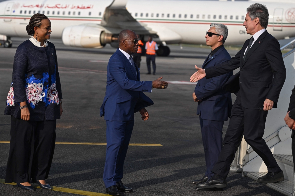 Ivory Coast's Minister of Foreign Affairs Kacou Houadja Leon Adom (2nd R) and US Ambassador to Ivory Coast Jessica Davis Ba (L) welcome US Secretary of State Antony Blinken (R) as he arrives at the Félix Houphouet-Boigny International Airport in Abidjan on January 22, 2024. (Photo by ANDREW CABALLERO-REYNOLDS / POOL / AFP)
