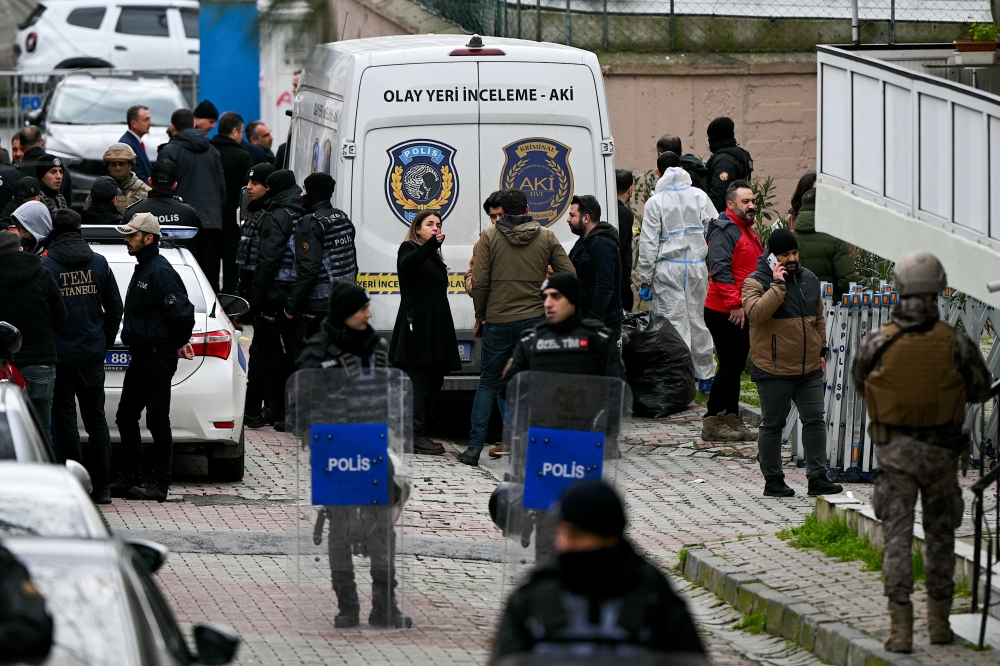 Turkish forensic police stand in front of Santa Maria church after an attack, in Istanbul, on January 28, 2024. (Photo by Ozan Kose / AFP)