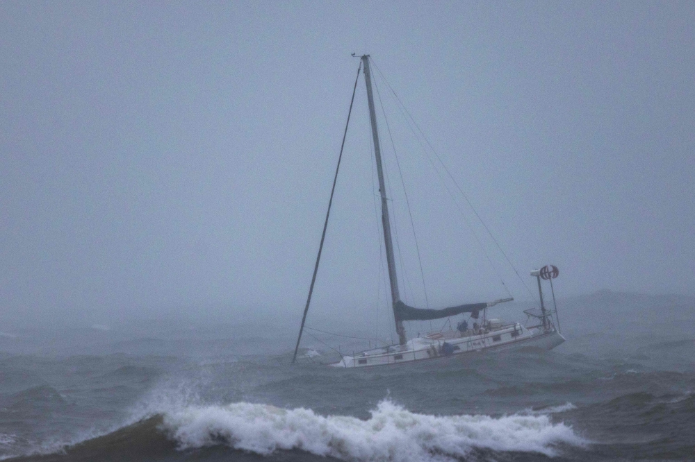 A boat moored offshore is tossed by rough waters as the second and more powerful of two atmospheric river storms arrives to Santa Barbara, California, on February 4, 2024. (Photo by David McNew / AFP)
 