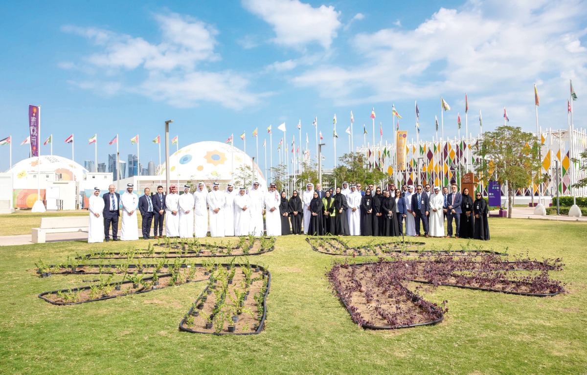 QNB officials taking part in the staff planting event at Expo Doha 2023.