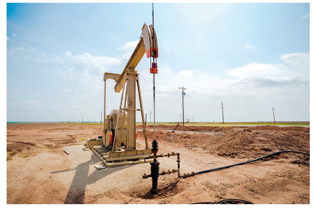 A single oil pumpjack on the plains of west Texas on a sunny day.