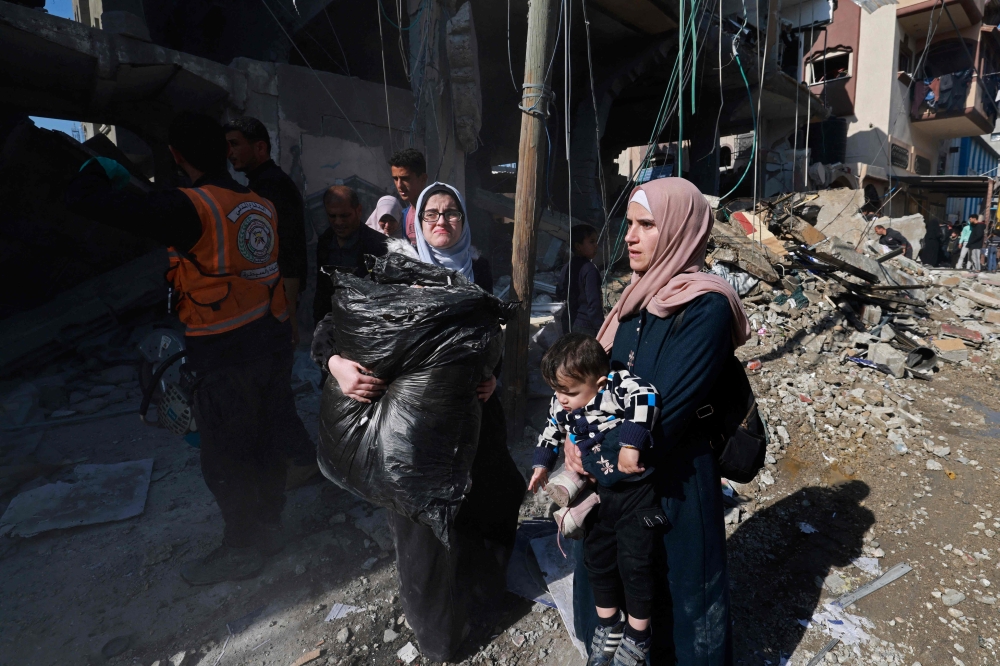 Palestinians flee their homes along with their belongings following Israeli bombardment in Rafah in the southern Gaza Strip on February 24, 2024, amid continuing battles between Israel and the Palestinian militant group Hamas. (Photo by MOHAMMED ABED / AFP)
