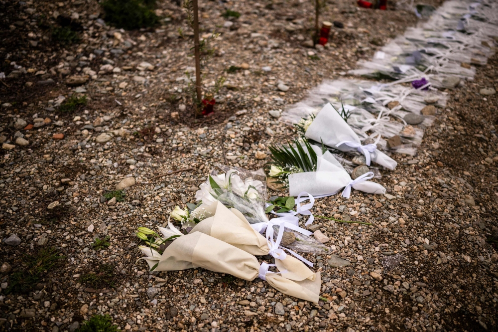 Bunches of flowers are displayed at the crash site in the Valley of Tempi, north of the central city of Larissa on February 28, 2024, during a memorial ceremony as the country marks a year since the 