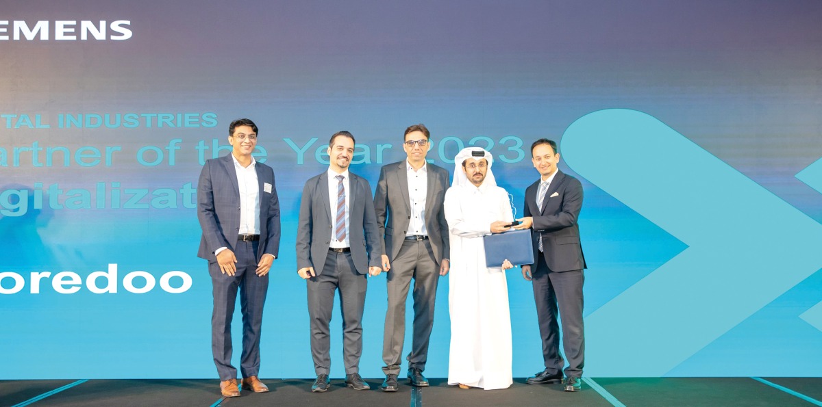 Ooredoo official receiving an award during the Siemens Partner Day.