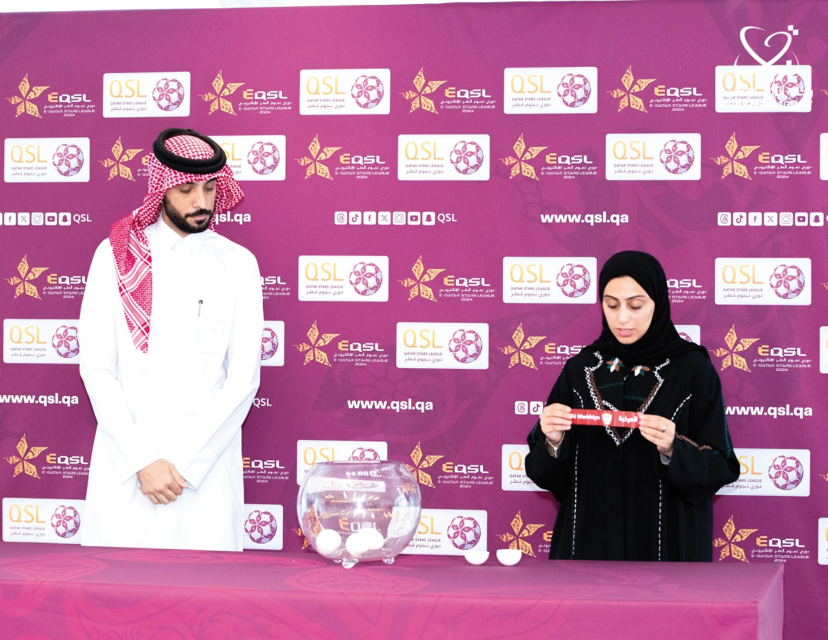 An official picks a team during the draw ceremony.
