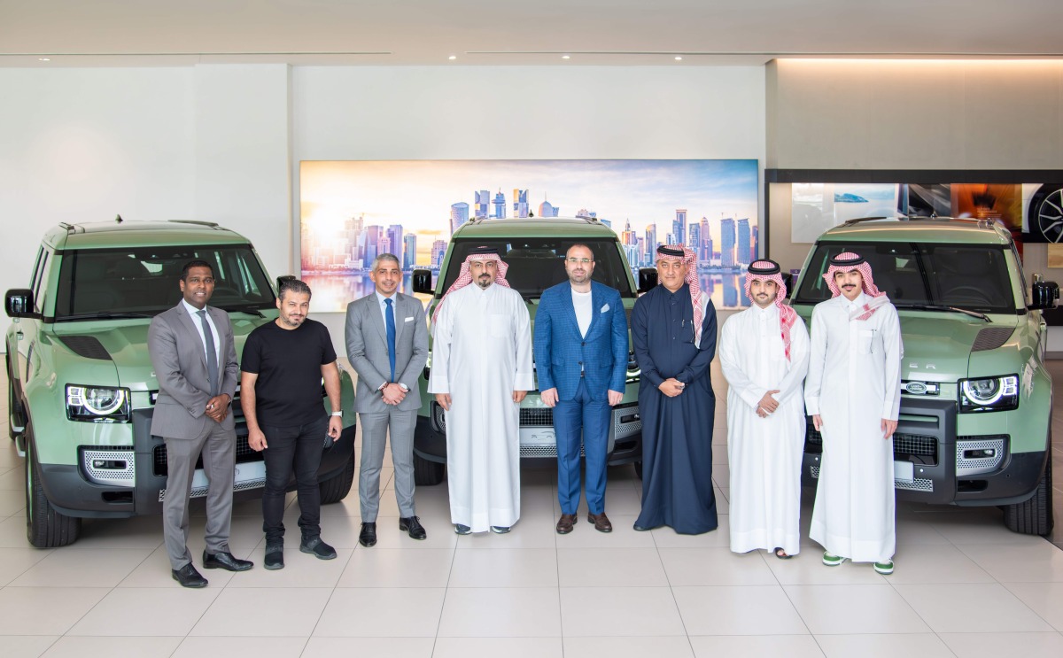 QNB and Visa officials pose for group photo with the winners of the winter campaign.