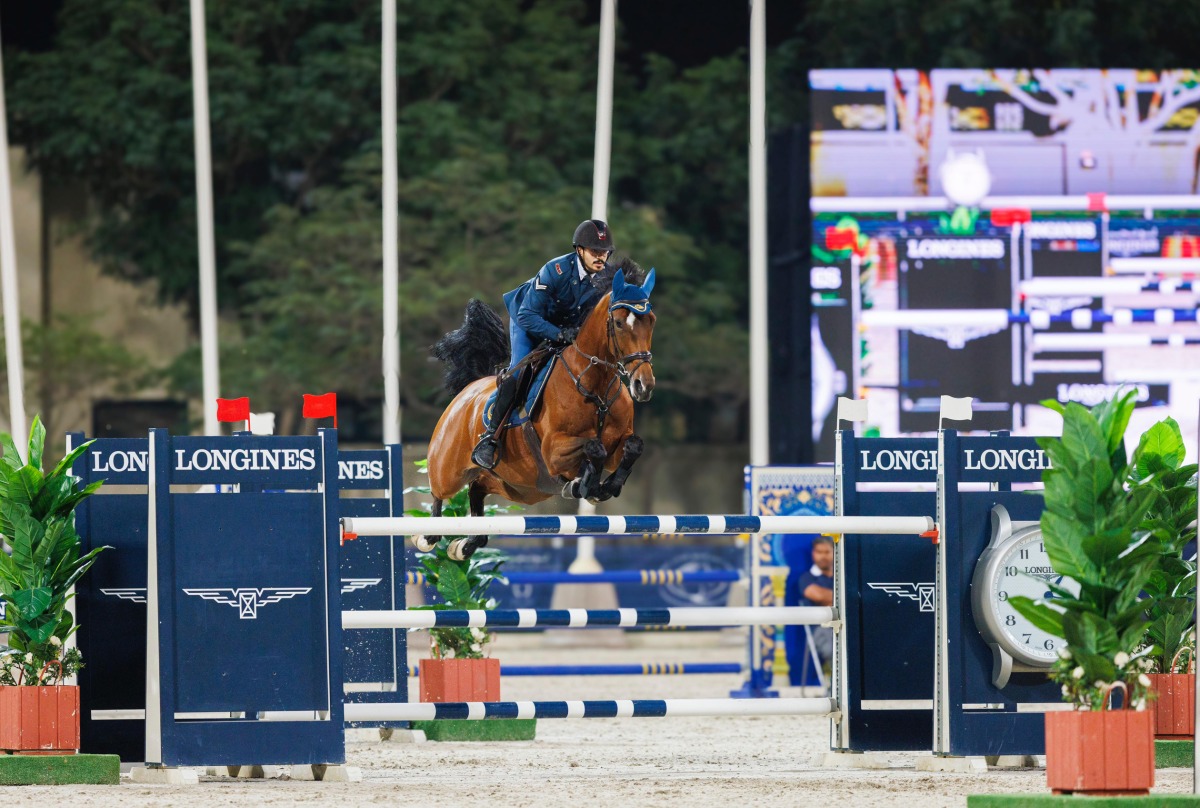 Hamad Nasser Al Qadi guides Happy Tina over a fence.