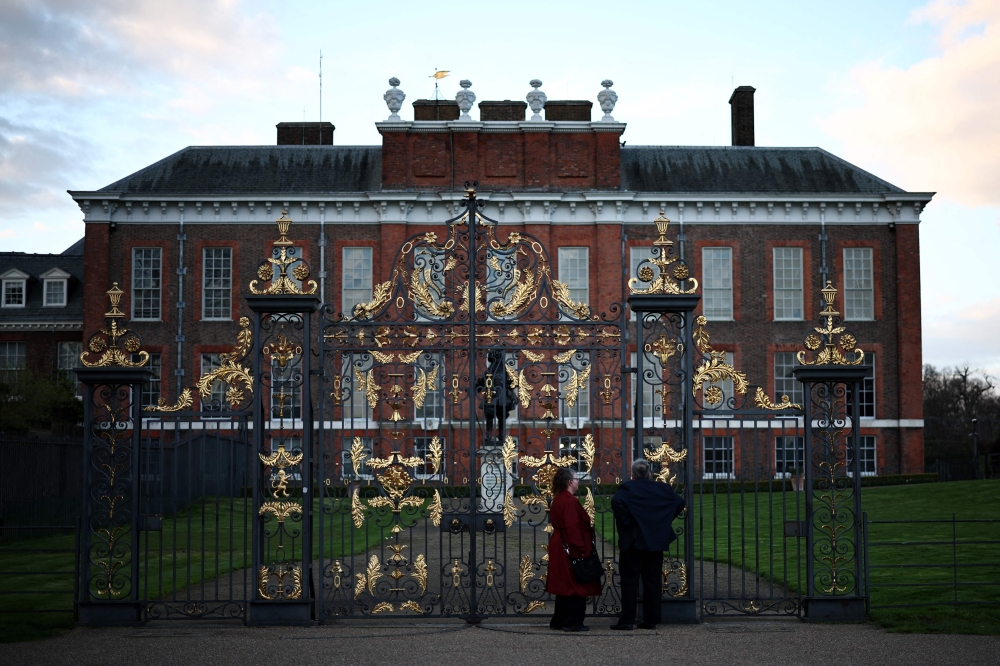 People stop by the gates of Kensington Palace in London on March 22, 2024. (Photo by Henry Nicholls / AFP)
 