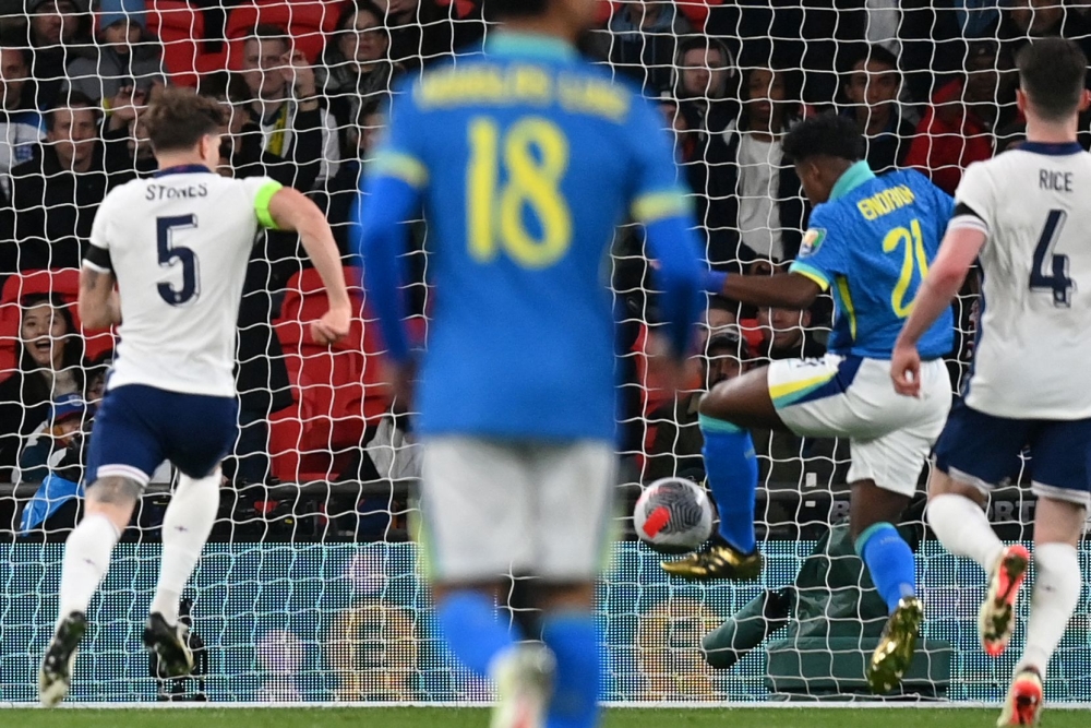 Brazil's striker #21 Endrick (2R) shoots to score the only goal of the international friendly football match between England and Brazil at Wembley stadium in north London on March 23, 2024. Brazil won the game 1-0. (Photo by Glyn KIRK / AFP)