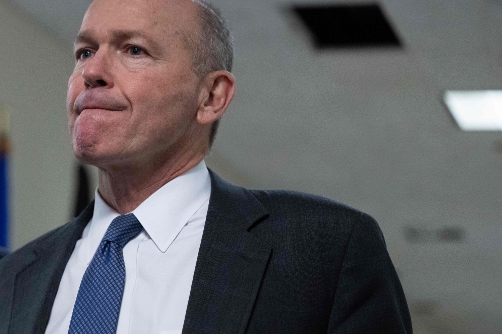 Boeing CEO Dave Calhoun speaks with reporters on Capitol Hill in Washington, DC, on January 24, 2024, before meeting with a group of senators. Boeing announced on March 25, 2024 that Calhoun will leave the company at the end of the year. (Photo by Jim WATSON / AFP)
