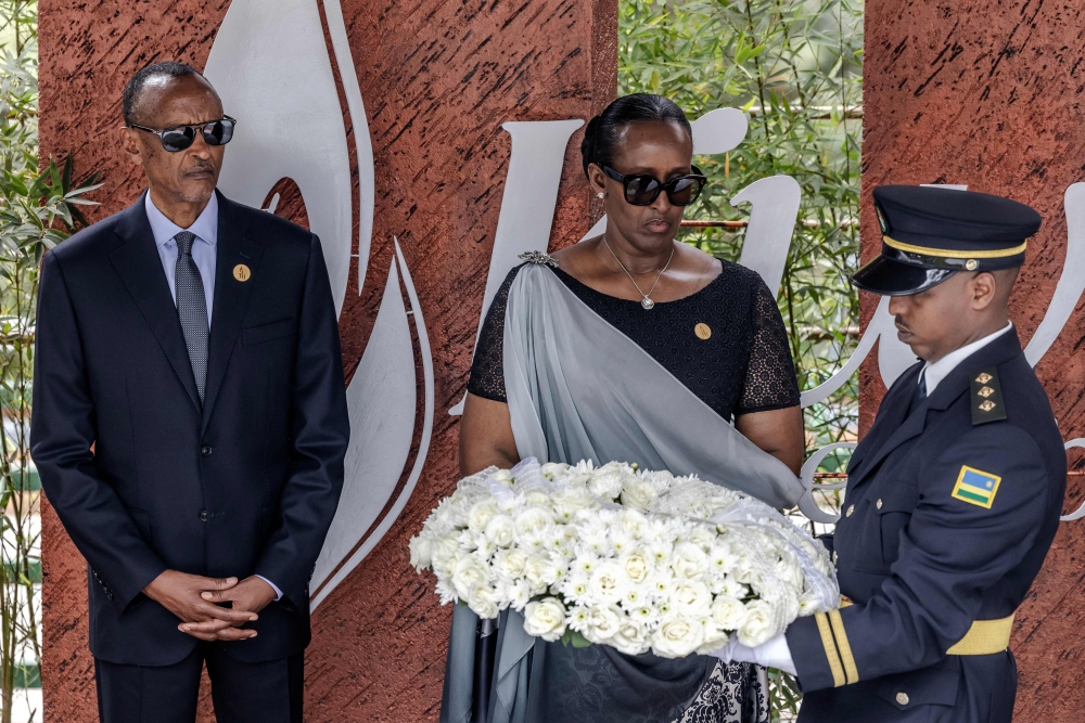 President of Rwanda Paul Kagame and First Lady of Rwanda Jeannette Kagame look on as a member of the Rwandan Military Band carries a wreath during the commemorations of the 30th Anniversary of the 1994 Rwandan genocide at the Kigali Genocide Memorial in Kigali on April 7, 2024. (Photo by LUIS TATO / AFP)
