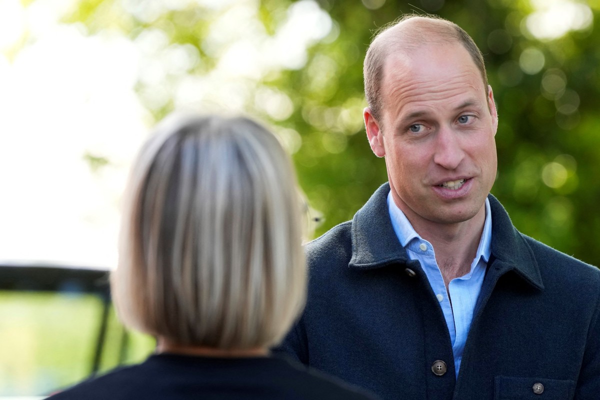 Britain's Prince William, Prince of Wales is greeted as he arrives for a visit to Surplus to Supper, a surplus food redistribution charity, in Sunbury-on-Thames, Surrey, England, on April 18, 2024. (Photo by Alastair Grant / POOL / AFP)
