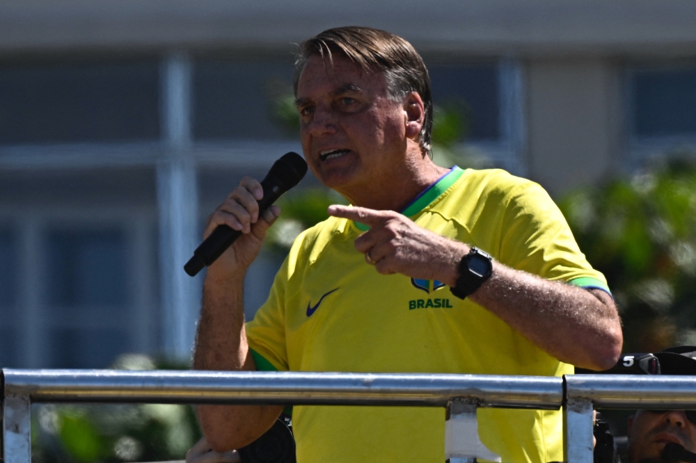 Former Brazilian President Jair Bolsonaro speaks to supporters during a demonstration at Copacabana Beach in Rio de Janeiro, Brazil, on April 21, 2024. (Photo by MAURO PIMENTEL / AFP)
