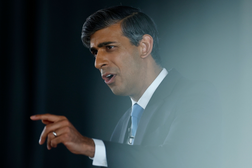 Britain's Prime Minister and Conservative Party leader Rishi Sunak delivers a speech to launch the Conservatives' general election manifesto in Silverstone, central England, on June 11, 2024, in the build-up to the UK general election on July 4. (Photo by BENJAMIN CREMEL / POOL / AFP)