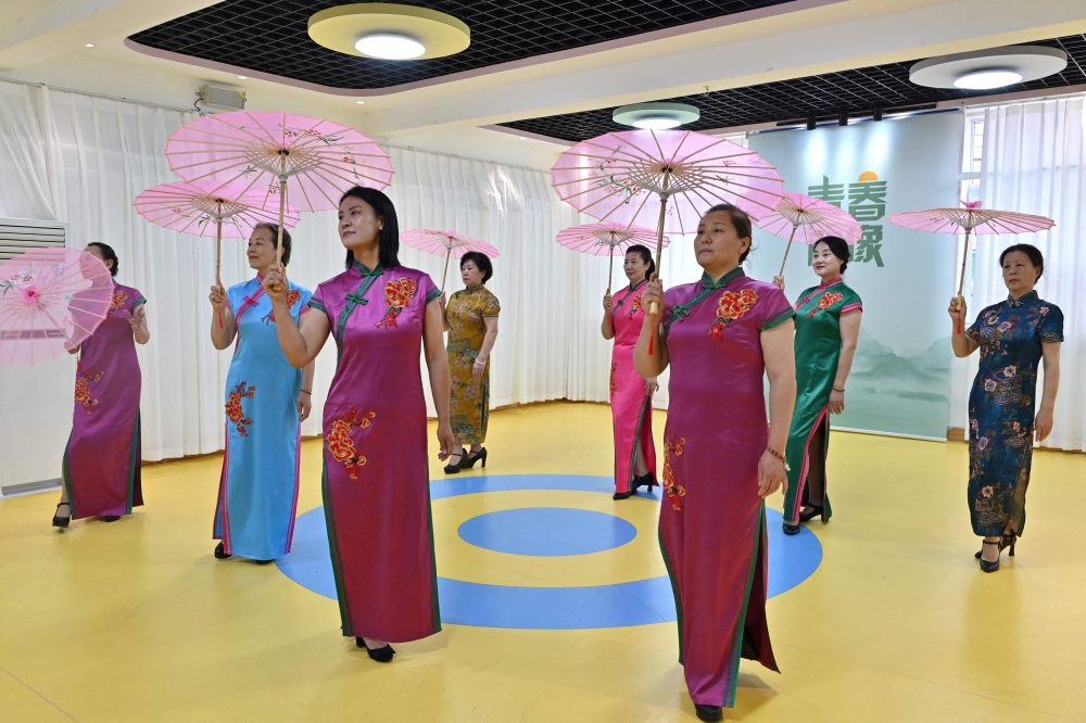 Participants practicing a dance at a kindergarten-turned-elderly centre in Taiyuan, in China's northern Shanxi province. (Photo by Adek Berry / AFP) 
