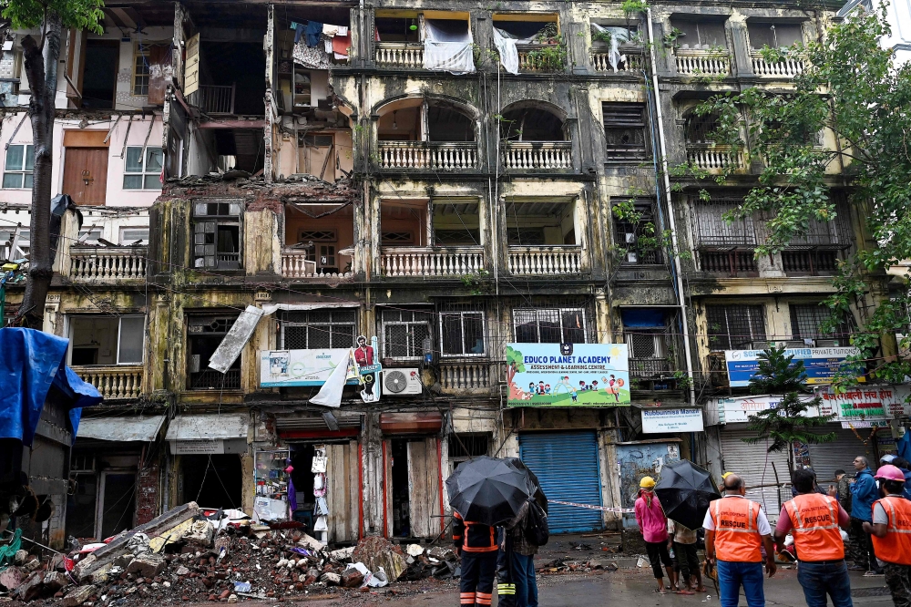 Rescue personnel gather outside the partially collapsed Rubinissa Manzil, a residential building in Mumbai on July 20, 2024. (Photo by Sujit Jaiswal / AFP)