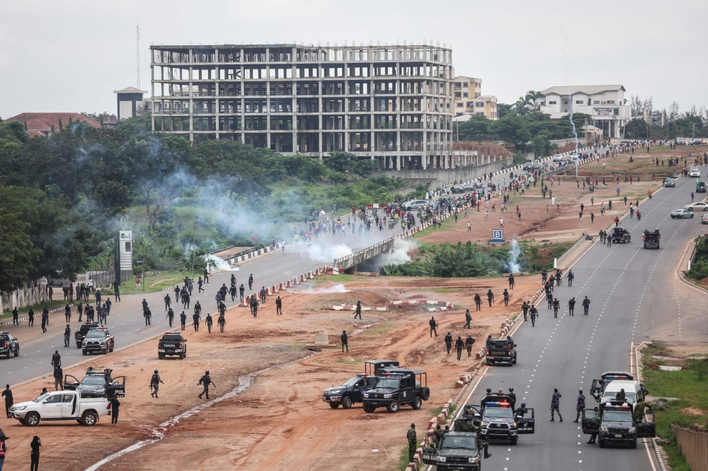 A cloud of tear gas fired by Nigerian security forces lingers during the End Bad Governance protest in Abuja on August 2, 2024. (Photo by Kola Sulaimon / AFP)