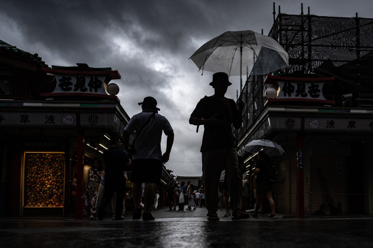 People visit Sensoji temple in Tokyo's Asakusa district on August 16, 2024, as Typhoon Ampil barrels towards Japan's capital. (Photo by Philip FONG / AFP)
