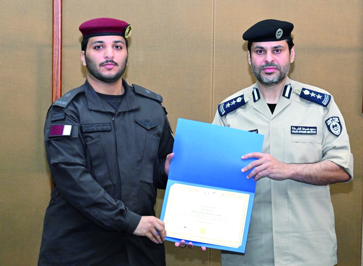 An officer being presented with the certificate at the end of the training.