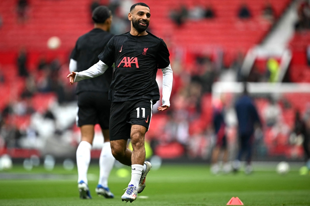 Liverpool's Egyptian striker #11 Mohamed Salah warms up ahead of the English Premier League football match between Manchester United and Liverpool at Old Trafford in Manchester, north west England, on September 1, 2024. Photo by Paul ELLIS / AFP.