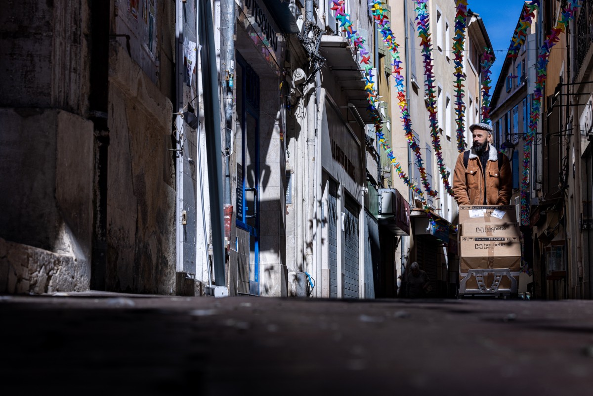 A deliveryman walks down a street in Manosque, southern France, on September 29, 2024. (Photo by JOEL SAGET / AFP)
