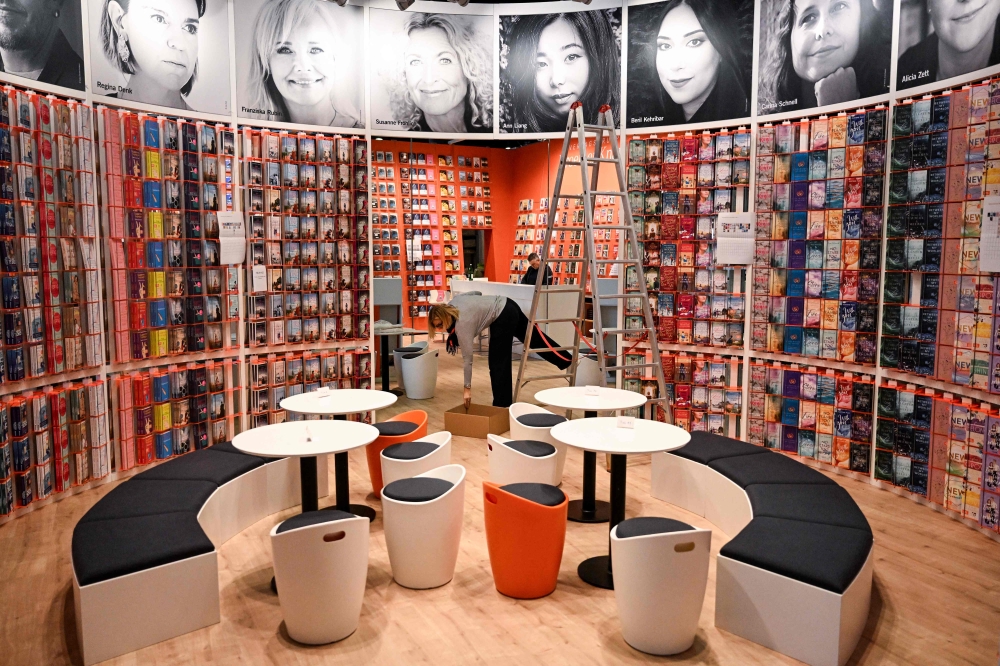 Employee prepares a booth at the Frankfurt book fair on October 15, 2024, prior to the opening of the world's biggest book fair in Frankfurt am Main, western Germany. (Photo by Kirill Kudryavtsev / AFP)