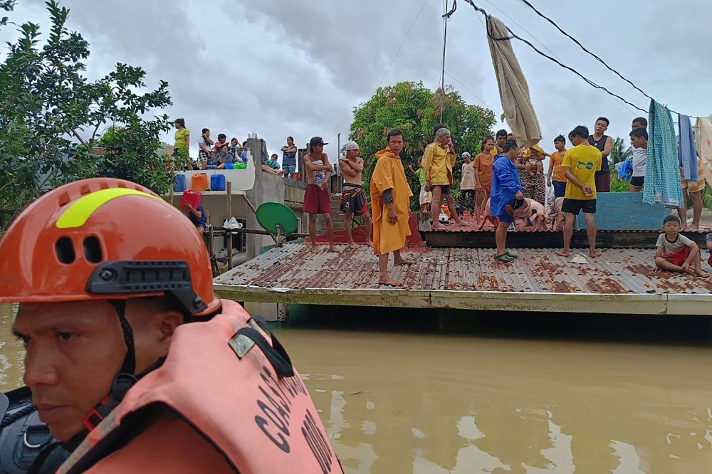In Photos: Seven dead, thousands evacuated as tropical storm batters Philippines
