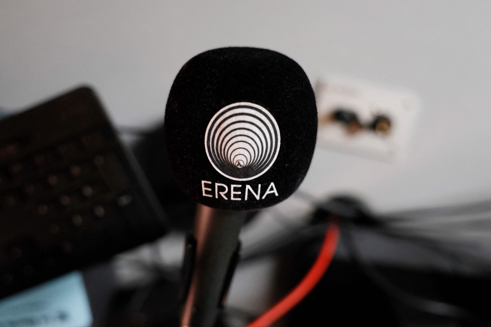 This photograph shows a microphone with the logo of Erena radio Erythree International in Paris, on October 31, 2024. (Photo by Gregoire Campione / AFP)