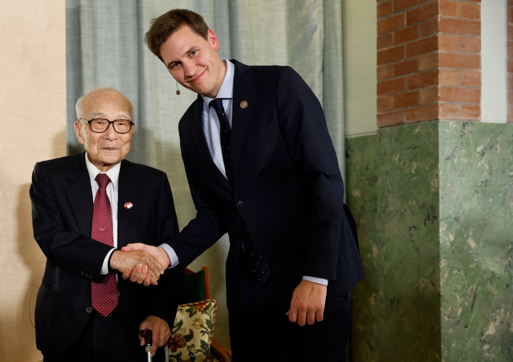 Norwegian politician Jorgen Watne Frydnes (R) shakes hands with Terumi Tanaka representing the 2024 Nobel Peace Prize winner, the Nihon Hidankyo group, at the end of a press conference in Oslo, Norway, on December 9, 2024, on the eve of the Nobel Peace Prize ceremony. (Photo by Odd ANDERSEN / AFP)
 