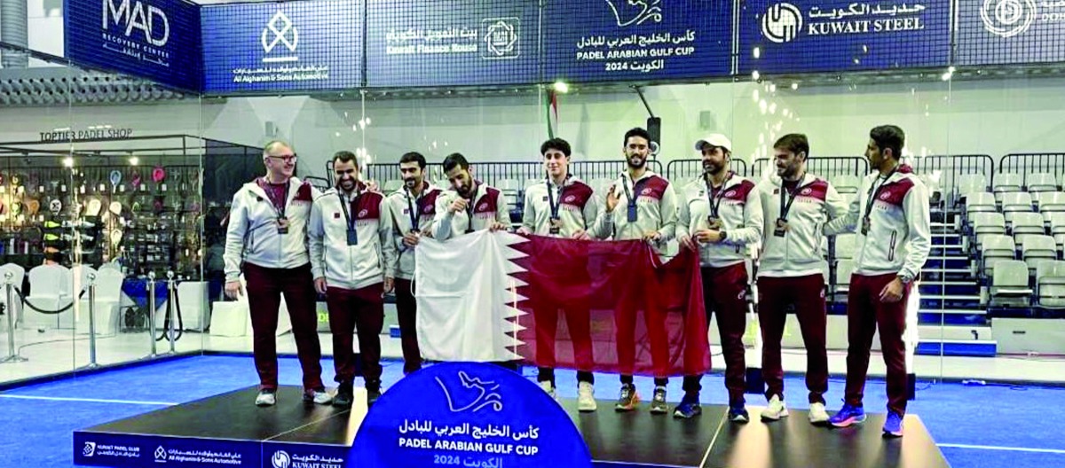 Qatar's players pose on the podium.