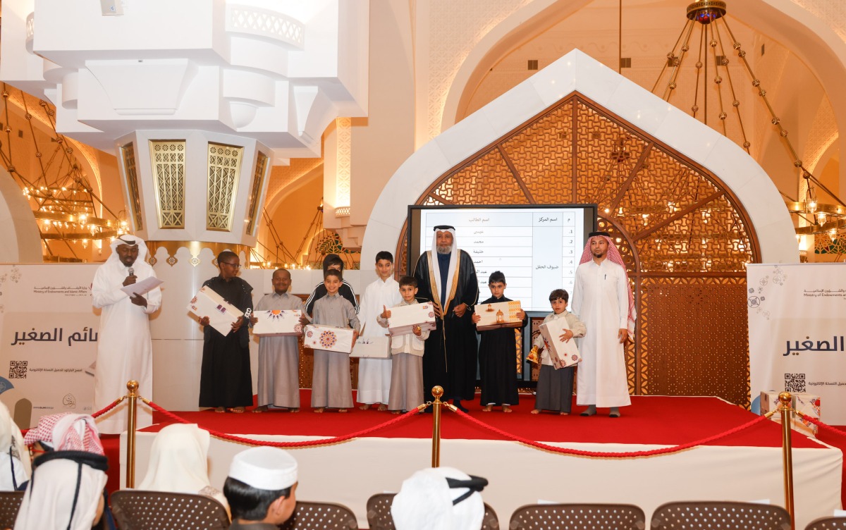 Officials with children during the event.