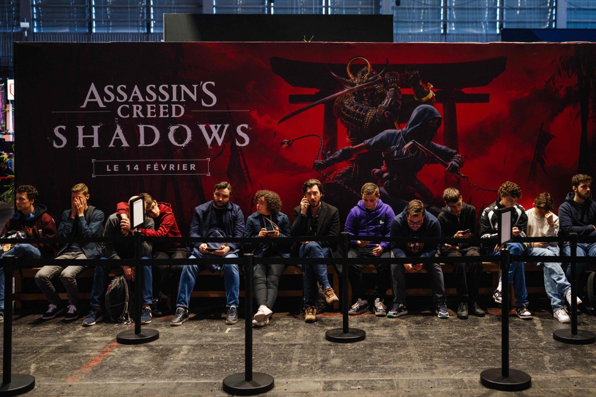 Visitors wait in line to play the 