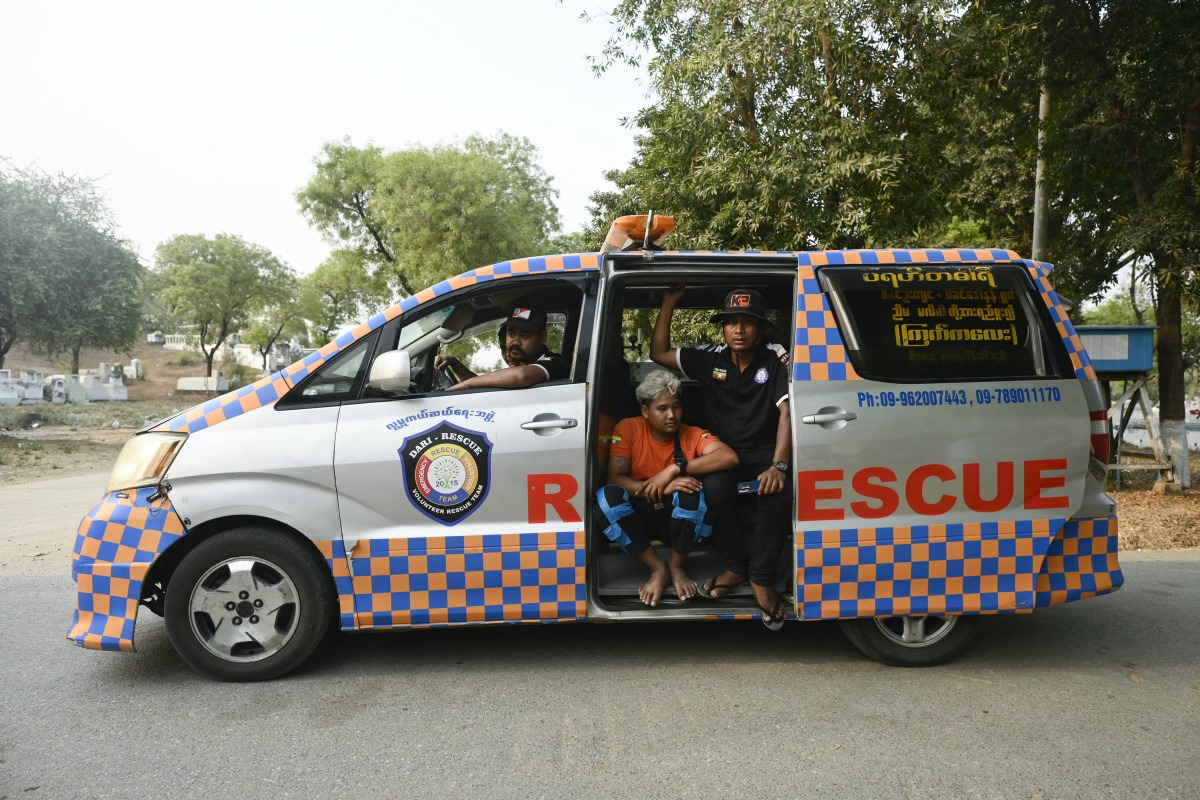 Rescue workers are seen in their vehicle after transporting the body of a victim to be buried at the Aye Yate Nyein Cemetery in Mandalay on March 31, 2025, three days after the deadly Myanmar earthquake. Photo by Sai Aung MAIN / AFP