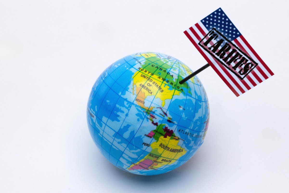 This photograph taken in Paris on April 8, 2025 shows a globe with a USA flag with the inscription 