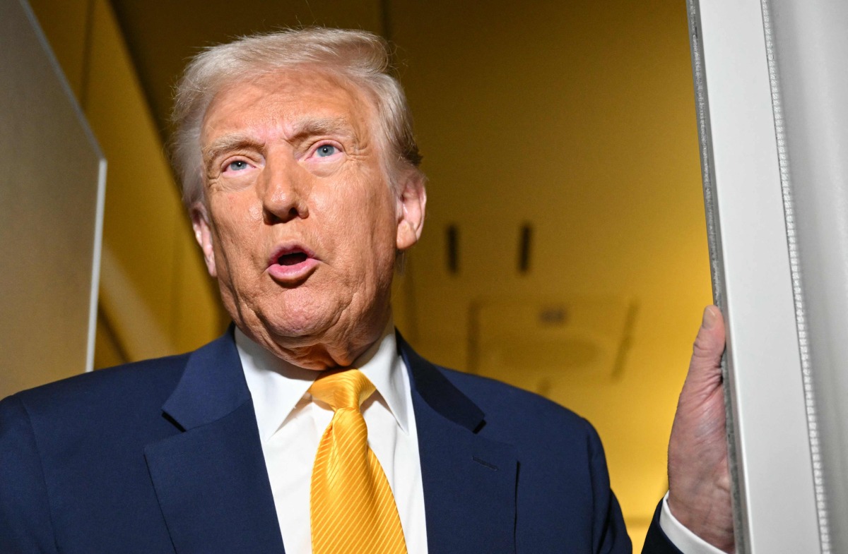 US President Donald Trump speaks to reporters during the flight from Palm Beach to Miami aboard Air Force One on April 12, 2025. Photo by Mandel NGAN / AFP